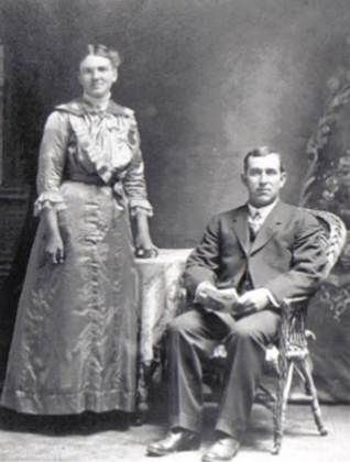 A vintage photo of a group of people posing for the camera

Description automatically generated